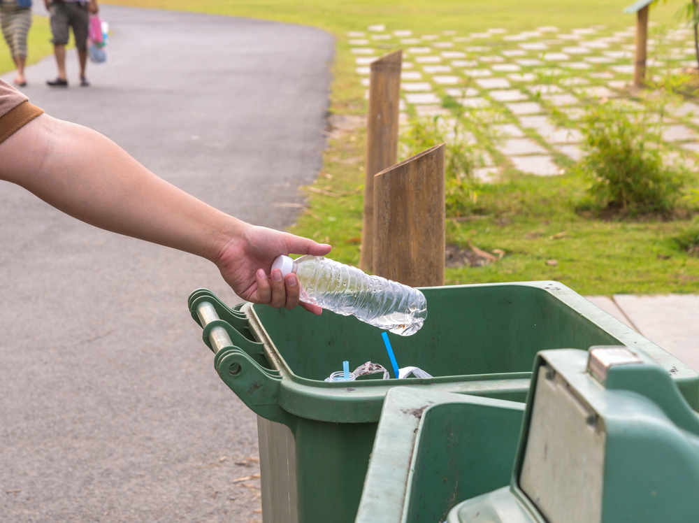 bottle in trash / eStudio, Shutterstock