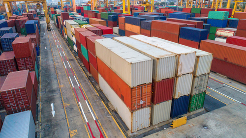 Shipping containers stacked at a port.