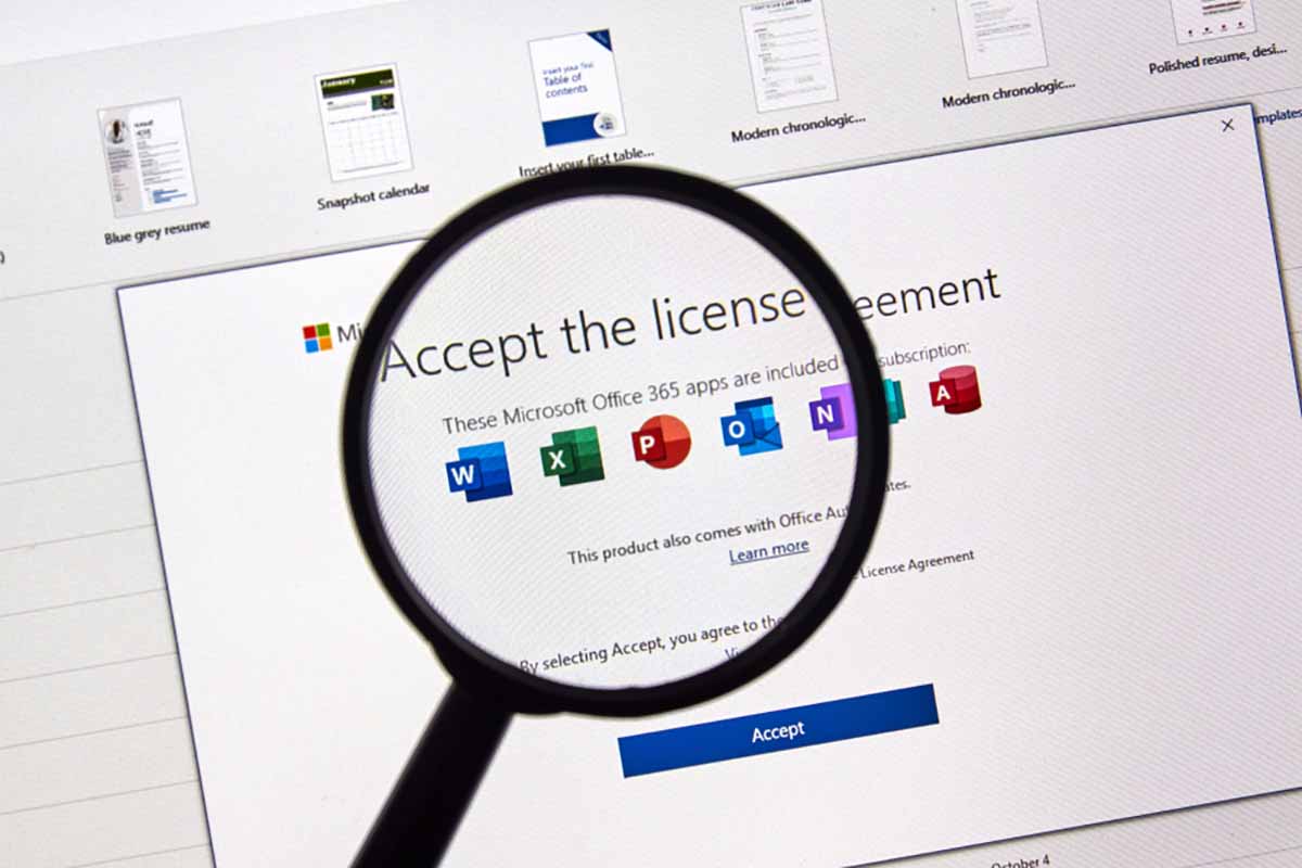 Microsoft Office license agreement screen under a magnifying glass.