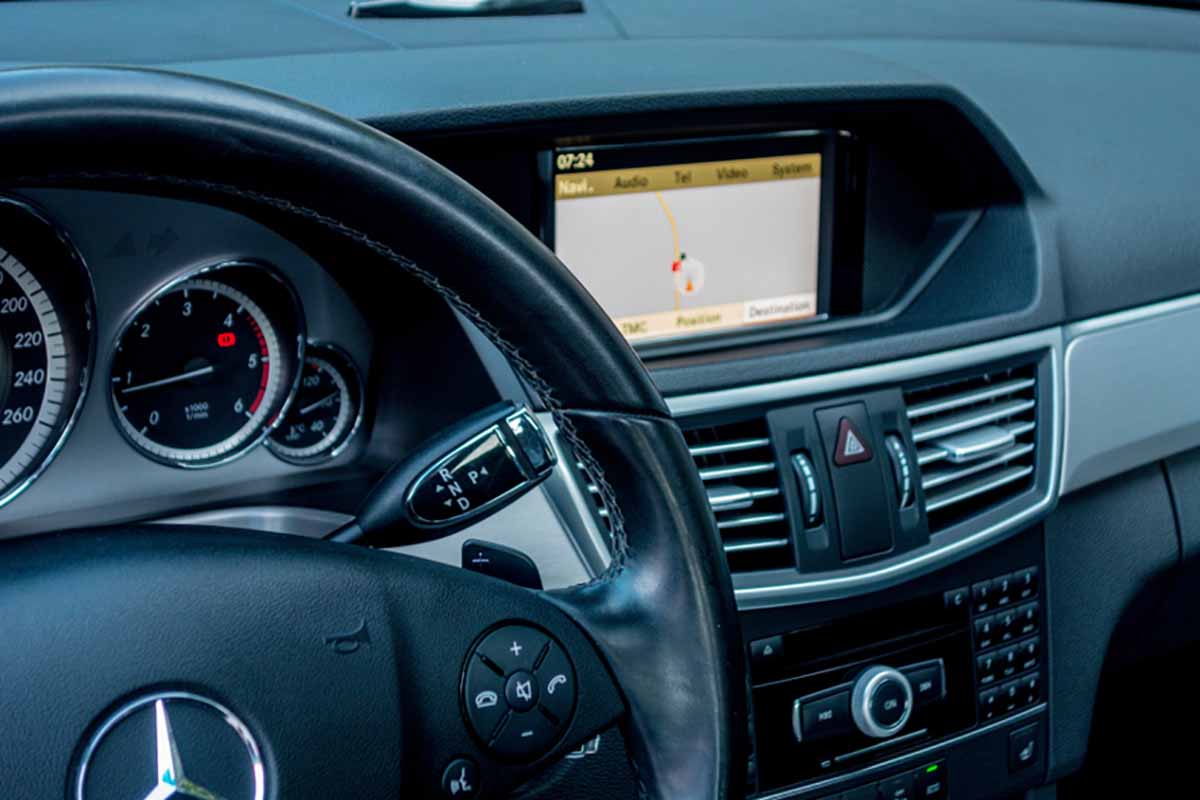 Interior of car showing the dash and information display screen.