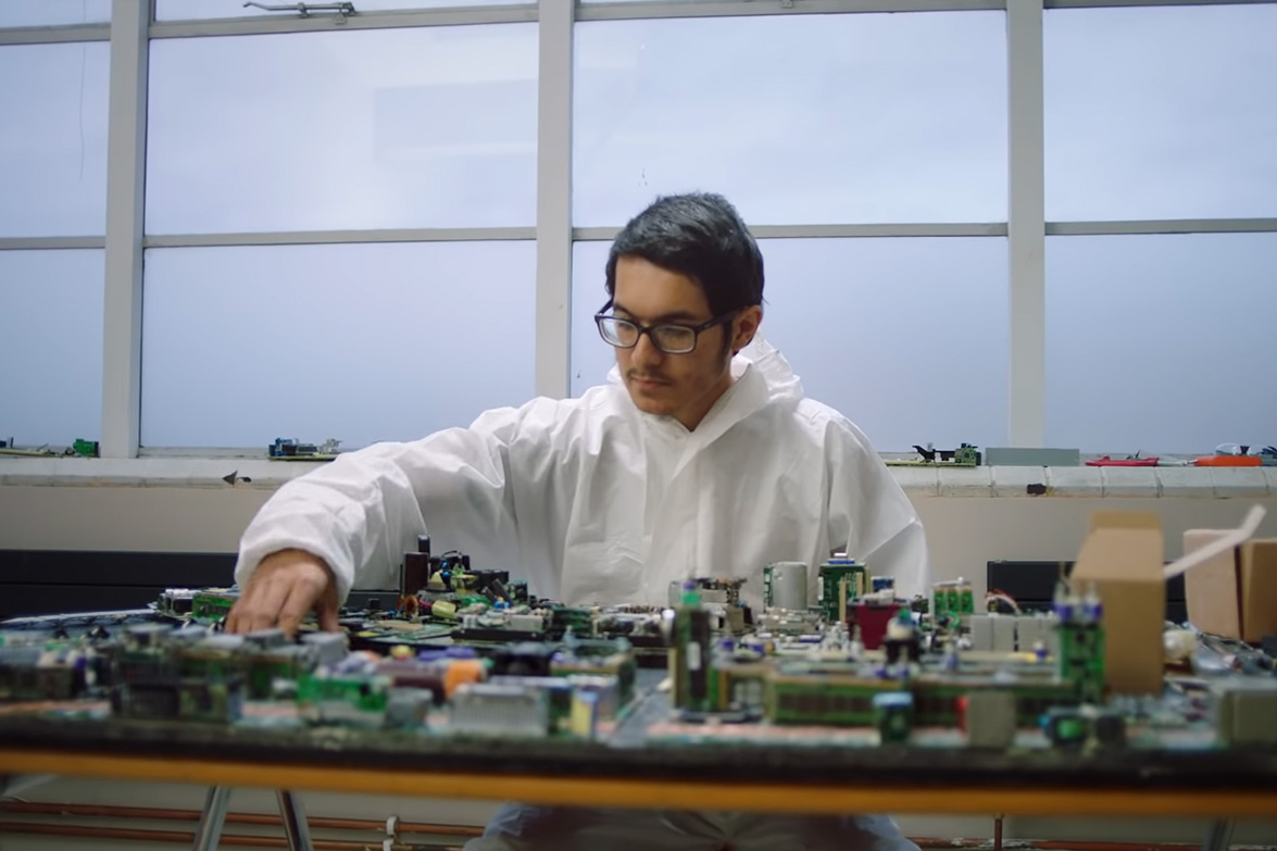 Artist with area of London crafted from e-scrap.