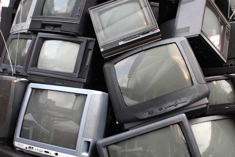 Pile of CRT televisions for recycling.