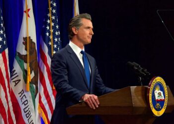 California Governor Gavin Newsom speaking at podium.