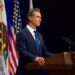 California Governor Gavin Newsom speaking at podium.