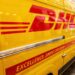 DHL truck parked on a city street.