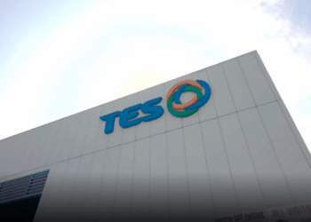 TES building with logo and sunny sky above.