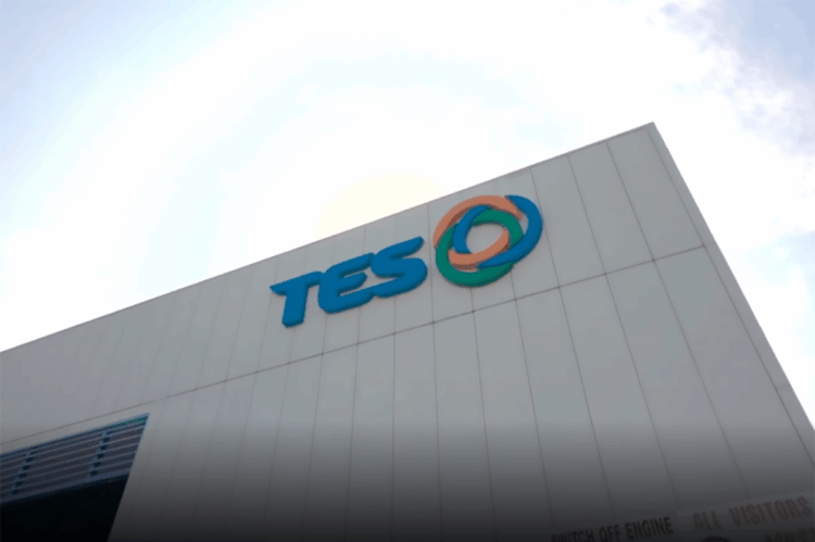 TES building with logo and sunny sky above.