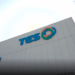 TES building with logo and sunny sky above.