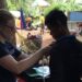 Researcher attaches monitoring device to e-scrap worker.