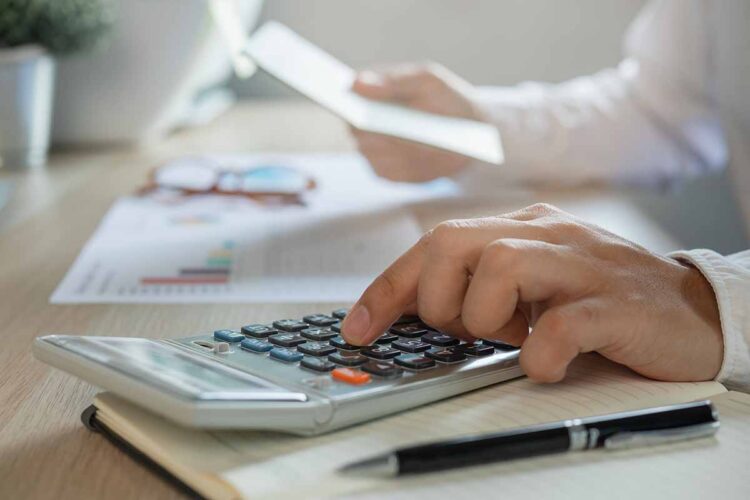 Calcuating at a desk.