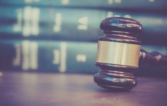 Court gavel with books in background.