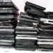 Laptop computers stacked for recycling.