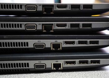 Laptops stacked for resale or recycling.
