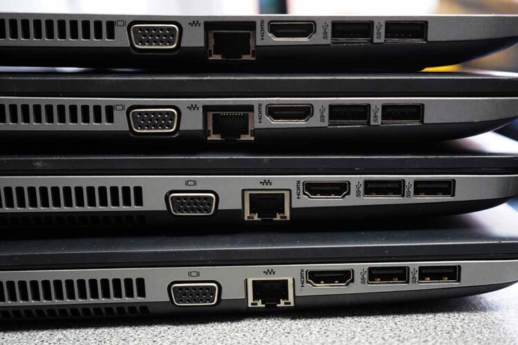 Laptops stacked for resale or recycling.