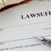 Documents to file a lawsuit with a pen.