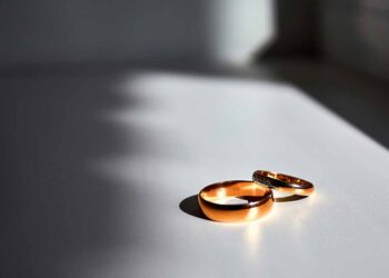 Wedding rings on a white table.