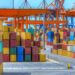 Shipping containers stacked at port.