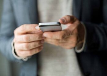 Person with smartphone in their hands.