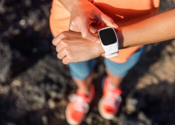 Person using a worn fitness tracker.